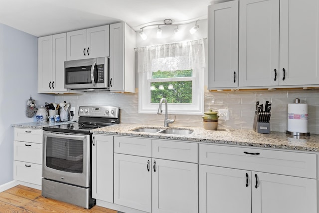 48 E Pasture Rd, Berwick, ME 03901 - kitchen featuring stainless steel appliances, a sink, decorative backsplash, and light stone countertops