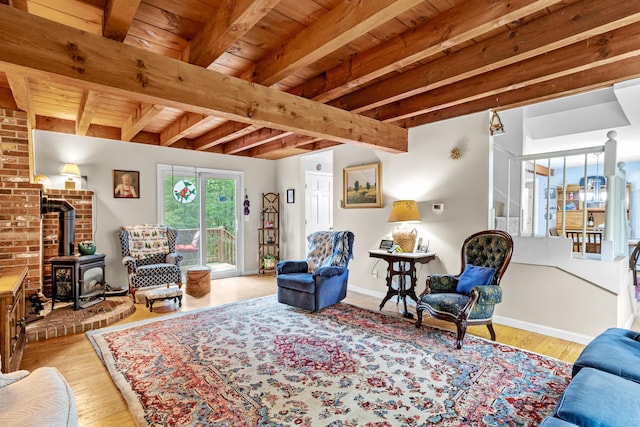 48 E Pasture Rd, Berwick, ME 03901 - living area with a wood stove, wood ceiling with exposed beams, wood finished floors, and baseboards