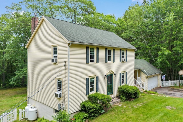 48 E Pasture Rd, Berwick, ME 03901 - colonial-style house featuring a chimney, asphalt driveway, a garage, and roof with shingles