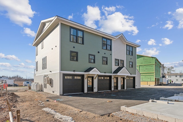22 Salt Point Dr Unit 23, Old Orchard Beach, ME 04064 - view of front of property featuring a garage, driveway, and board and batten siding