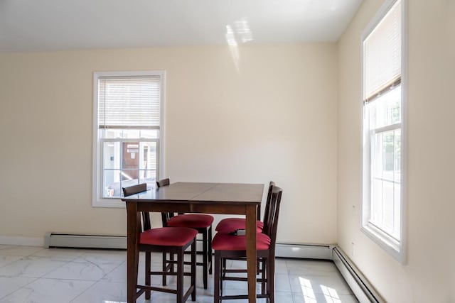 19 Mason St, Brunswick, ME 04011 - dining area featuring a baseboard radiator, light marble finish floors, and baseboards