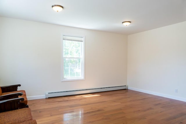 19 Mason St, Brunswick, ME 04011 - spare room featuring a baseboard heating unit, wood finished floors, and baseboards