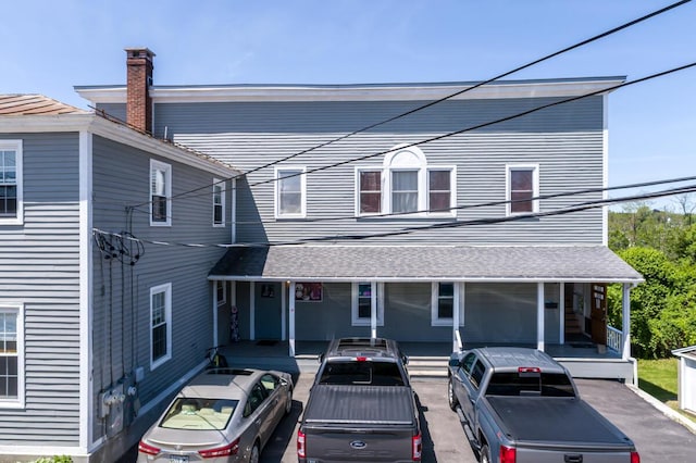 19 Mason St, Brunswick, ME 04011 - view of front of house featuring covered porch and a chimney