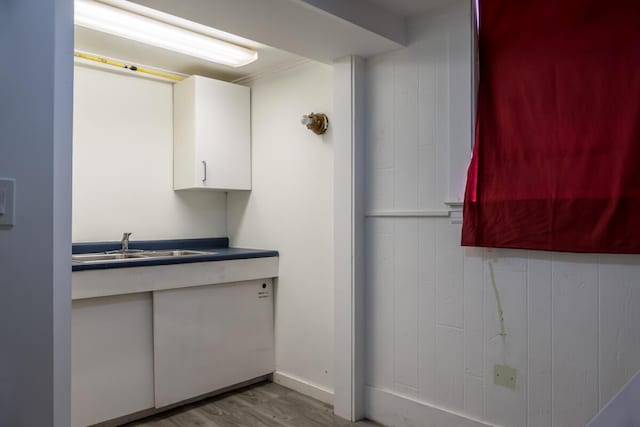 19 Mason St, Brunswick, ME 04011 - kitchen featuring white cabinets, a sink, wood finished floors, and dark countertops