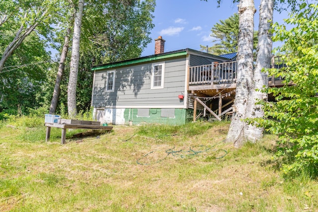 194 Main Rd, Passadumkeag, ME 04475 - back of property with a wooden deck, a chimney, and crawl space