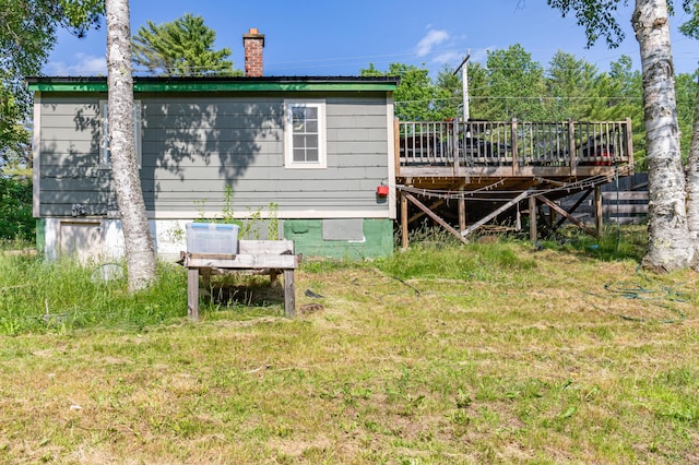 194 Main Rd, Passadumkeag, ME 04475 - rear view of house featuring a deck, a chimney, and a yard