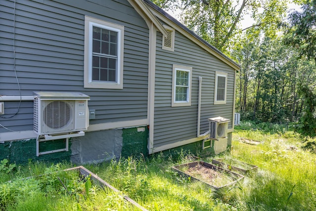 194 Main Rd, Passadumkeag, ME 04475 - view of home's exterior featuring an ac unit and a garden