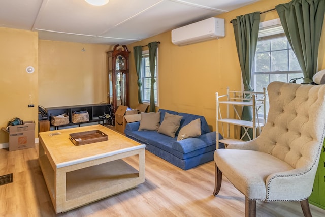 194 Main Rd, Passadumkeag, ME 04475 - living area featuring a wall mounted AC, plenty of natural light, and wood finished floors