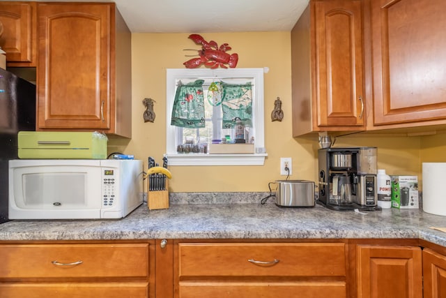 194 Main Rd, Passadumkeag, ME 04475 - kitchen featuring white microwave, brown cabinets, and light countertops