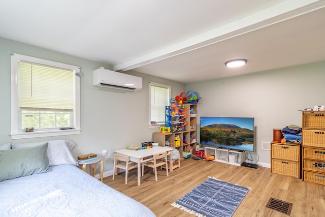 194 Main Rd, Passadumkeag, ME 04475 - bedroom with an AC wall unit, wood finished floors, multiple windows, and beam ceiling