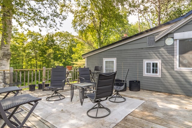 194 Main Rd, Passadumkeag, ME 04475 - wooden terrace featuring outdoor dining space and view of wooded area