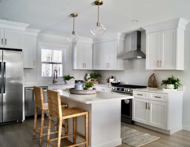 24 Salt Point Dr Unit 24, Old Orchard Beach, ME 04064 - kitchen featuring appliances with stainless steel finishes, wall chimney range hood, wood finished floors, light countertops, and a sink