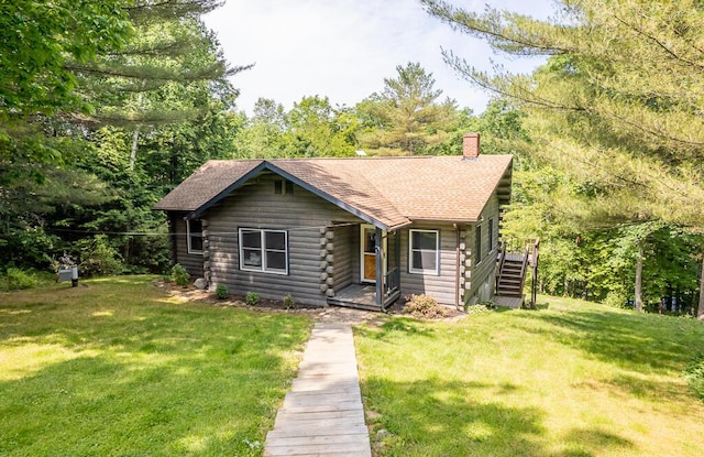 1103 Rte 135, Monmouth, ME 04259 - log-style house featuring log siding, a chimney, a front yard, and a shingled roof