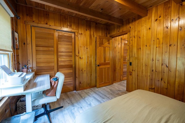 1103 Rte 135, Monmouth, ME 04259 - bedroom with wood finished floors, wood walls, a wood ceiling with exposed beams, and a closet