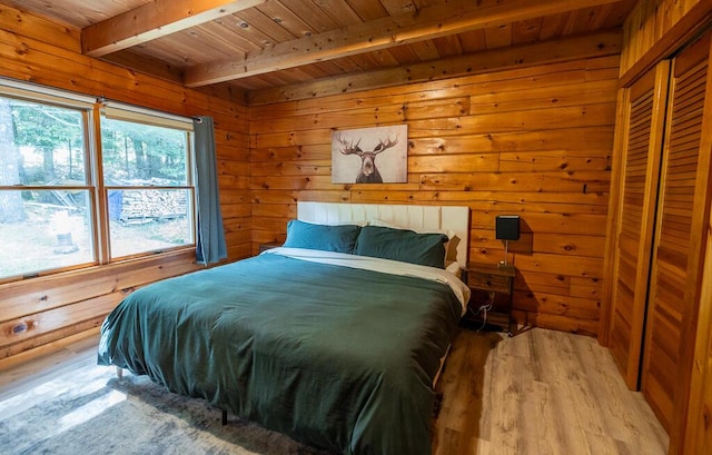 1103 Rte 135, Monmouth, ME 04259 - bedroom featuring a wood ceiling with exposed beams, light wood-style flooring, and wood walls