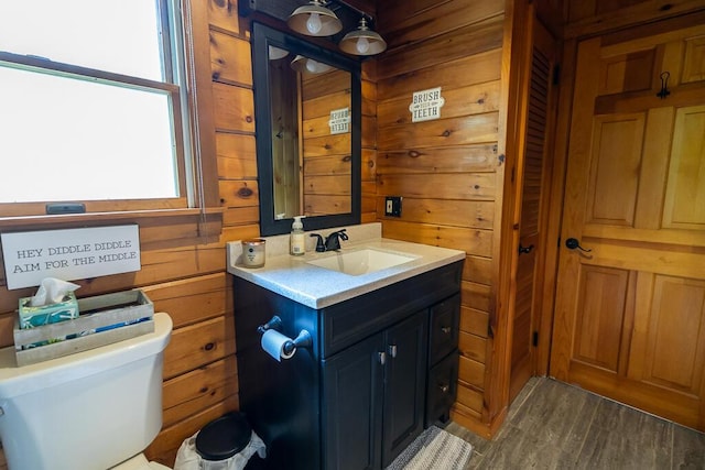 1103 Rte 135, Monmouth, ME 04259 - half bath with vanity, plenty of natural light, wood finished floors, and wood walls