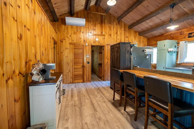 1103 Rte 135, Monmouth, ME 04259 - kitchen featuring refrigerator, wooden walls, green cabinetry, light wood finished floors, and wood ceiling