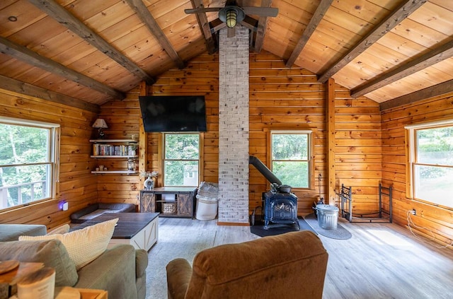 1103 Rte 135, Monmouth, ME 04259 - living room featuring a wood stove, wooden ceiling, healthy amount of natural light, wooden walls, and wood finished floors