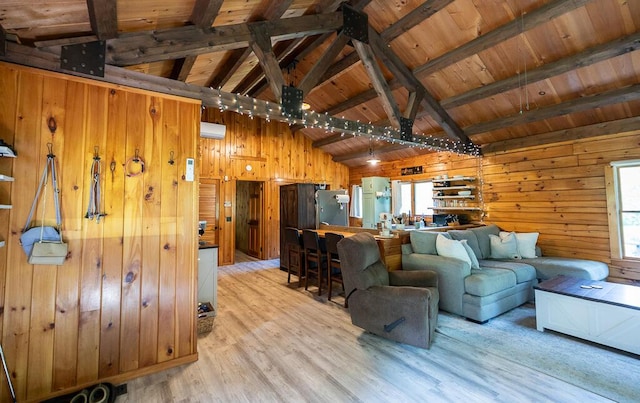 1103 Rte 135, Monmouth, ME 04259 - living area featuring light wood-style flooring, wooden walls, a wooden ceiling with exposed beams, and high vaulted ceiling