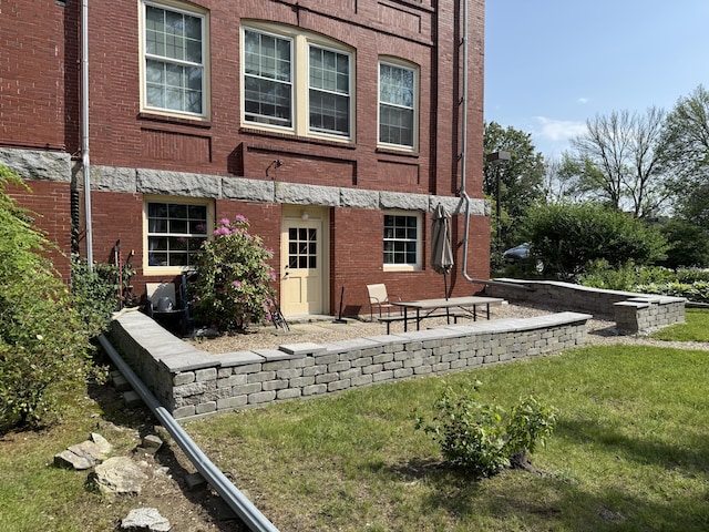 245 Broadway Unit 106, South Portland, ME 04106 - rear view of property with a yard and brick siding