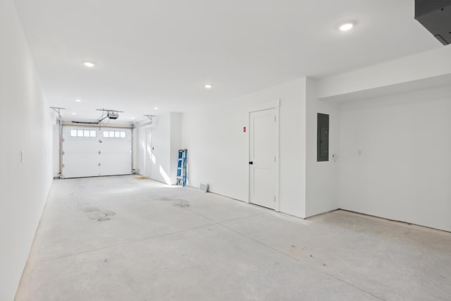 26 Salt Point Dr Unit 25, Old Orchard Beach, ME 04064 - garage with electric panel, a garage door opener, and recessed lighting