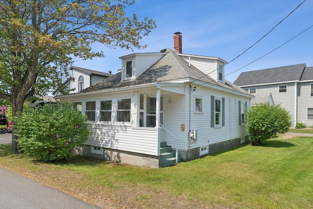 134 W Grand Ave, Old Orchard Beach, ME 04064 - view of home's exterior with a chimney and a lawn