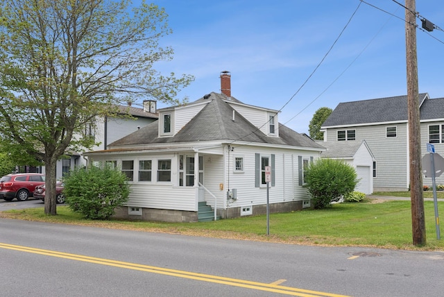 134 W Grand Ave, Old Orchard Beach, ME 04064 - view of front facade featuring a chimney, a front lawn, entry steps, and a shingled roof