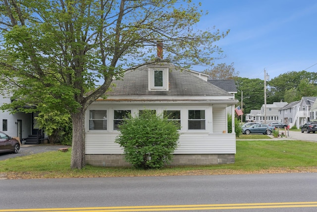 134 W Grand Ave, Old Orchard Beach, ME 04064 - view of front of house with a front lawn and a shingled roof
