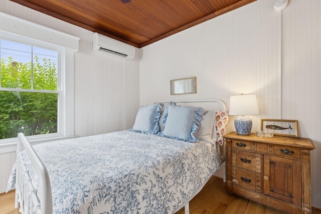 134 W Grand Ave, Old Orchard Beach, ME 04064 - bedroom featuring a wall mounted AC, wood ceiling, wood finished floors, and ornamental molding