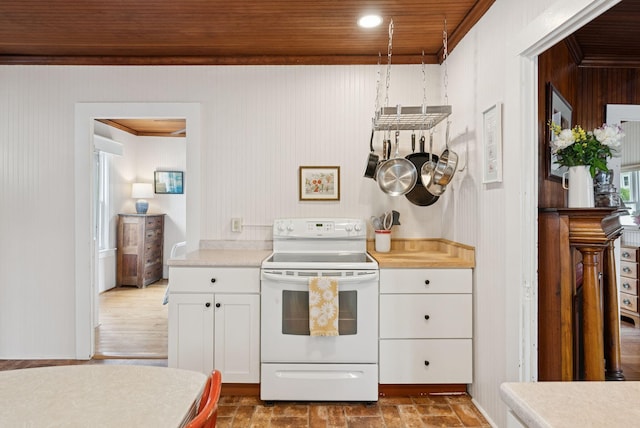 134 W Grand Ave, Old Orchard Beach, ME 04064 - kitchen featuring white electric range, white cabinetry, light countertops, and ornamental molding