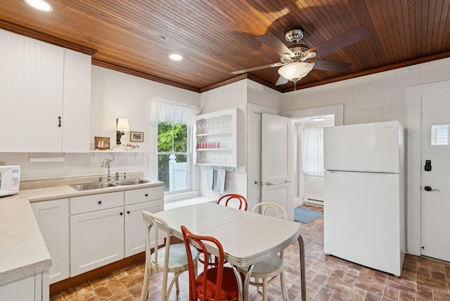 134 W Grand Ave, Old Orchard Beach, ME 04064 - kitchen featuring white appliances, wood ceiling, crown molding, ceiling fan, and white cabinets