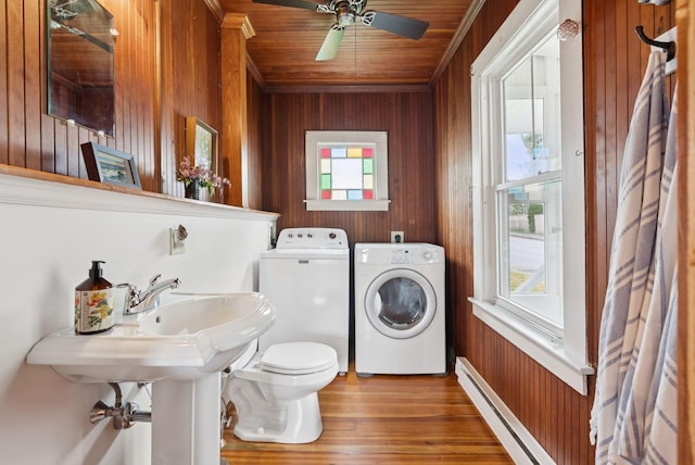 134 W Grand Ave, Old Orchard Beach, ME 04064 - half bath featuring healthy amount of natural light, wooden walls, a baseboard radiator, washer and dryer, and wood finished floors