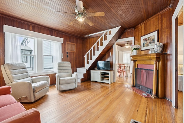 134 W Grand Ave, Old Orchard Beach, ME 04064 - living room with wood walls, ceiling fan, stairs, a fireplace, and wooden ceiling