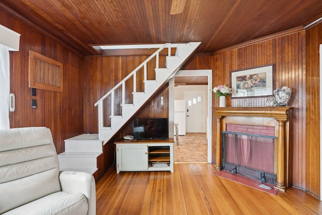 134 W Grand Ave, Old Orchard Beach, ME 04064 - living area with wood walls, stairs, wood ceiling, a fireplace, and wood finished floors