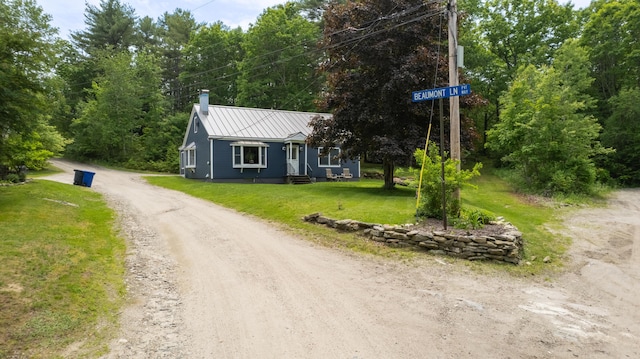 188 Old Chadbourne Rd, Lewiston, ME 04240 - view of front of home featuring a chimney, a front lawn, metal roof, a standing seam roof, and driveway