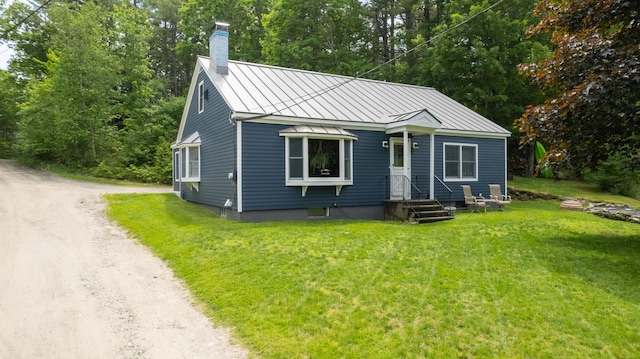 188 Old Chadbourne Rd, Lewiston, ME 04240 - bungalow-style house with a standing seam roof, driveway, a chimney, metal roof, and a front yard