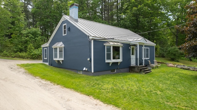 188 Old Chadbourne Rd, Lewiston, ME 04240 - view of front of property with a standing seam roof, a chimney, driveway, metal roof, and a front lawn
