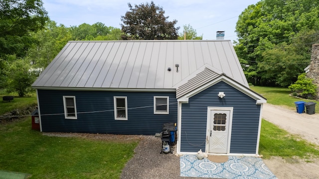 188 Old Chadbourne Rd, Lewiston, ME 04240 - view of front of home with a chimney, a standing seam roof, a front yard, and metal roof