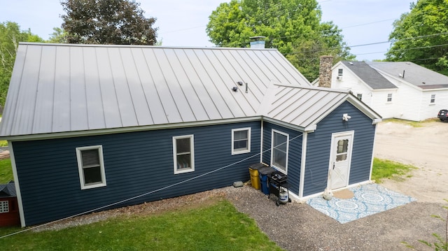188 Old Chadbourne Rd, Lewiston, ME 04240 - back of house with a standing seam roof, a chimney, and metal roof