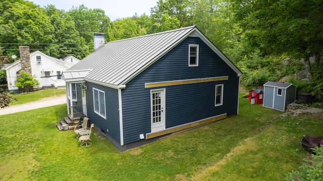 188 Old Chadbourne Rd, Lewiston, ME 04240 - rear view of house with a standing seam roof, a chimney, metal roof, a yard, and entry steps
