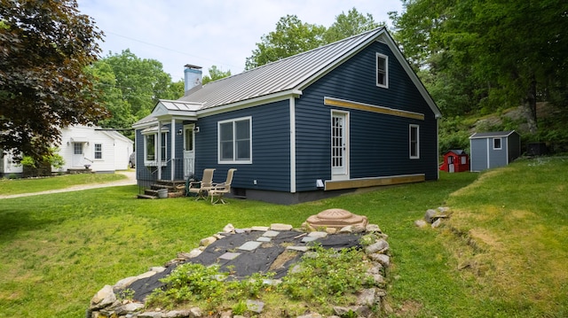 188 Old Chadbourne Rd, Lewiston, ME 04240 - rear view of house with a chimney, metal roof, a yard, and a standing seam roof
