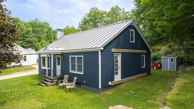 188 Old Chadbourne Rd, Lewiston, ME 04240 - back of property with a standing seam roof, a chimney, metal roof, and a lawn
