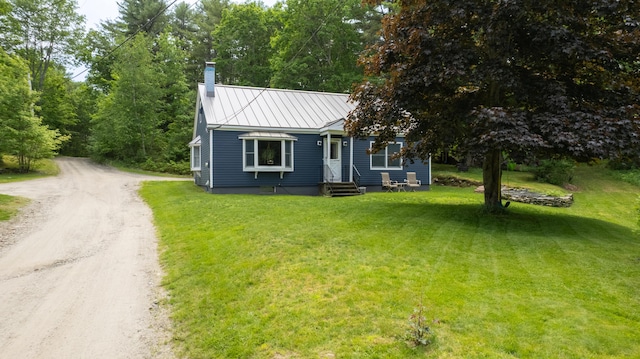 188 Old Chadbourne Rd, Lewiston, ME 04240 - view of front facade with driveway, a chimney, a front yard, and metal roof