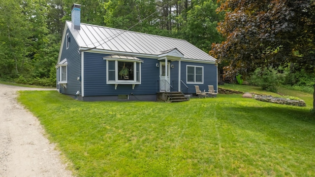 188 Old Chadbourne Rd, Lewiston, ME 04240 - bungalow-style house with a chimney, a standing seam roof, a front lawn, and metal roof