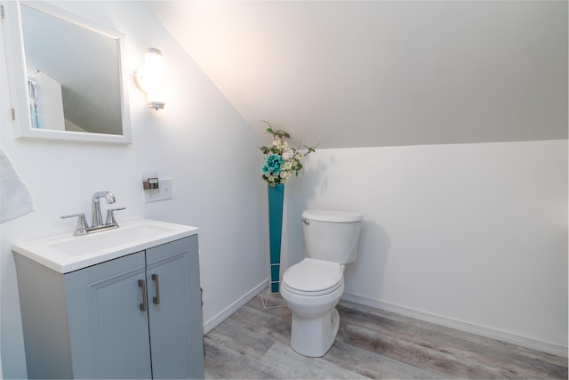 188 Old Chadbourne Rd, Lewiston, ME 04240 - half bath with vanity, toilet, wood finished floors, lofted ceiling, and baseboards