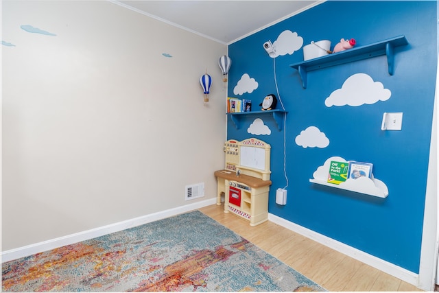 188 Old Chadbourne Rd, Lewiston, ME 04240 - playroom featuring wood finished floors, ornamental molding, and baseboards