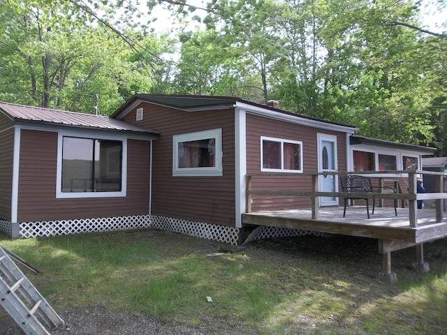 41 Hickory Ln, Alexander, ME 04694 - rear view of house with a wooden deck, metal roof, and a yard
