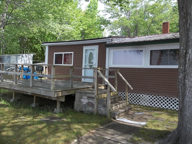 41 Hickory Ln, Alexander, ME 04694 - back of house featuring a chimney, metal roof, and a deck