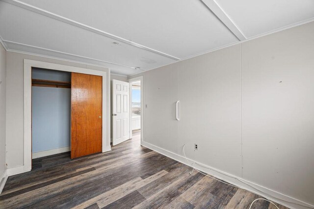 511 Ocean Ave, Wells, ME 04090 - unfurnished bedroom with wood finished floors, a closet, and ornamental molding