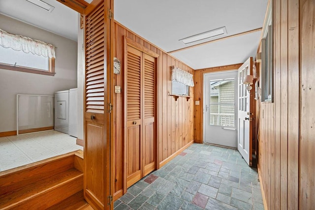 511 Ocean Ave, Wells, ME 04090 - hallway with stone tile flooring, washer / clothes dryer, and wooden walls